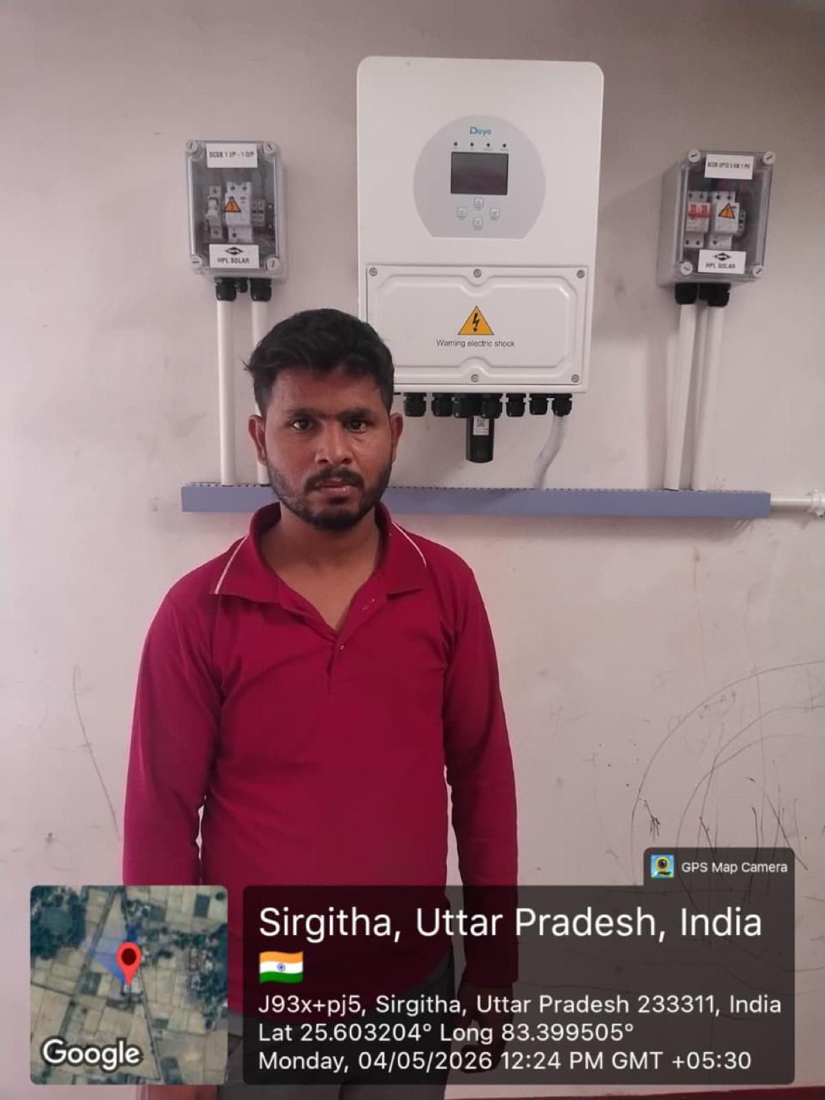 Customer standing beside a Pratap Solar Agency inverter installation in Sirgitha